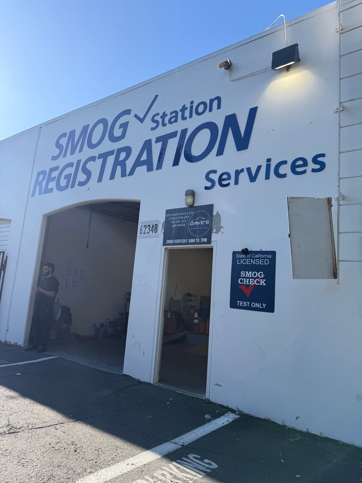 Shop entrance with the placard showing the address, phone number, and 8 AM to 7 PM hours, beside the STAR certified sign